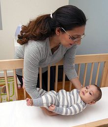 Baby_on_Back_photo mother laying baby on back in crib