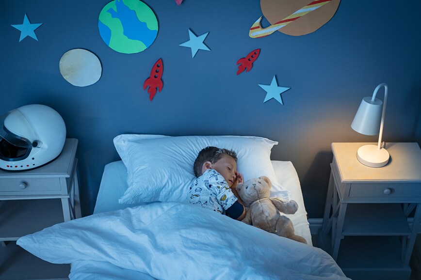 child taking a nap in bed