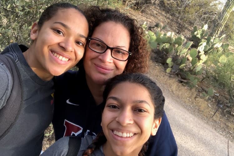 Foto de Robin, una sobreviviente de melanoma, con sus hijas