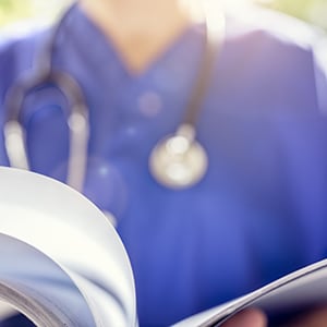 medical staff with reference document