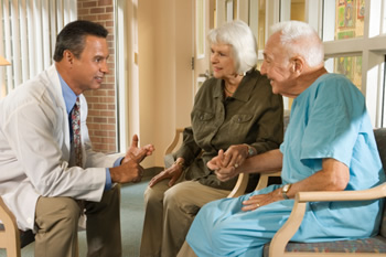 doc-talking-to-couple-86529245-350w.jpg Photo: Doctor speaking to an older couple