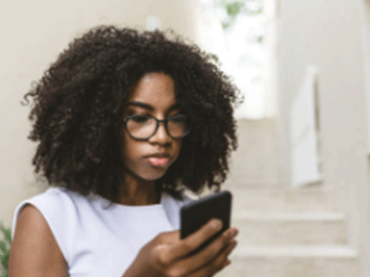young girl looking at her smart phone