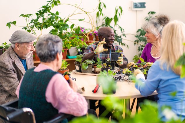 Group of senior friends enjoying gardening together