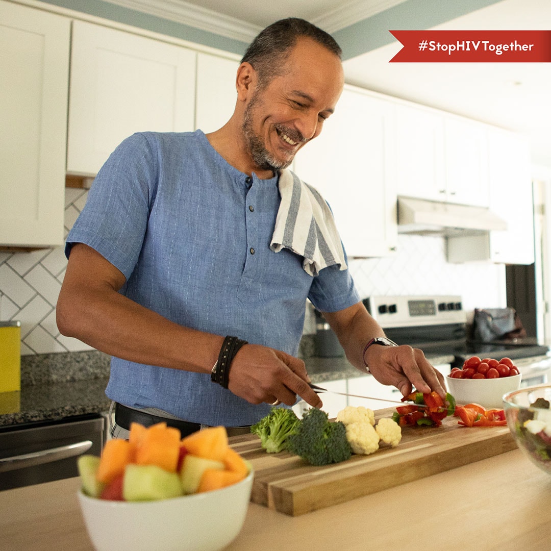 Healthy Aging – Eddie An image of a man chopping vegetables in his kitchen.