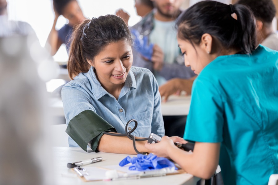 prevent-stroke A woman getting her blood pressure checked.