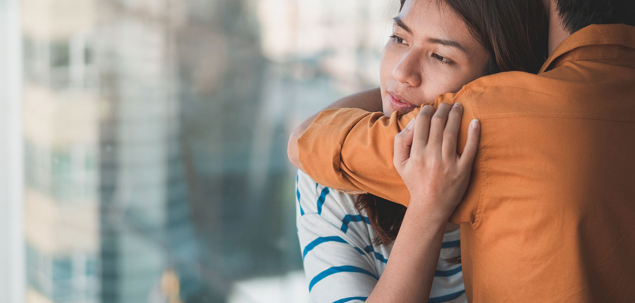 Image of a teen giving her father a hug