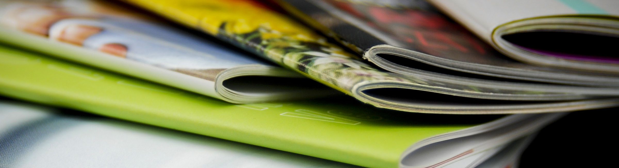 Picture of several publications laying on top of one another