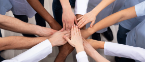 View Of Doctors Stacking Hands