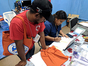 Communityworker Photo Caption: Community worker Joel Bujen and Nurse Adela Sibok-Nakamura prepare 3HP for community distribution in Majuro in June, 2018.