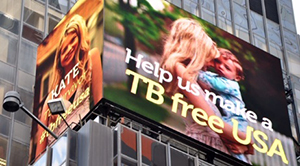 Kate Kate O’Brien and her son Jimmy on the NYC Times Square Jumbotron. Space secured by NTCA.