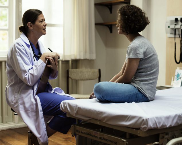 Doctor is checking patient symptom image of a doctor talking to a female patient