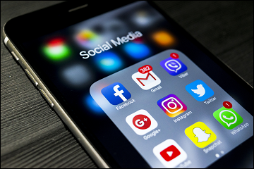 Cellphone showing screen with social media apps