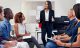 Group in a meeting with one person speaking Group in a meeting with one person speaking