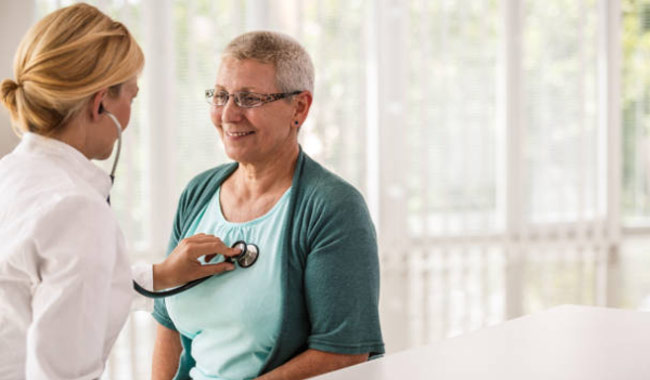 doctor listening to patient's heartbeat