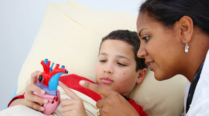 Doctor takling to a patient in a hospital bed Doctor takling to a patient in a hospital bed