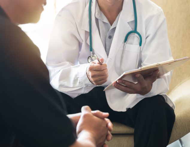 Men's health exam with doctor or psychiatrist working with patient having consultation on diagnostic examination on male disease or mental illness in medical clinic or hospital mental health service Men's health exam with doctor or psychiatrist working with patient