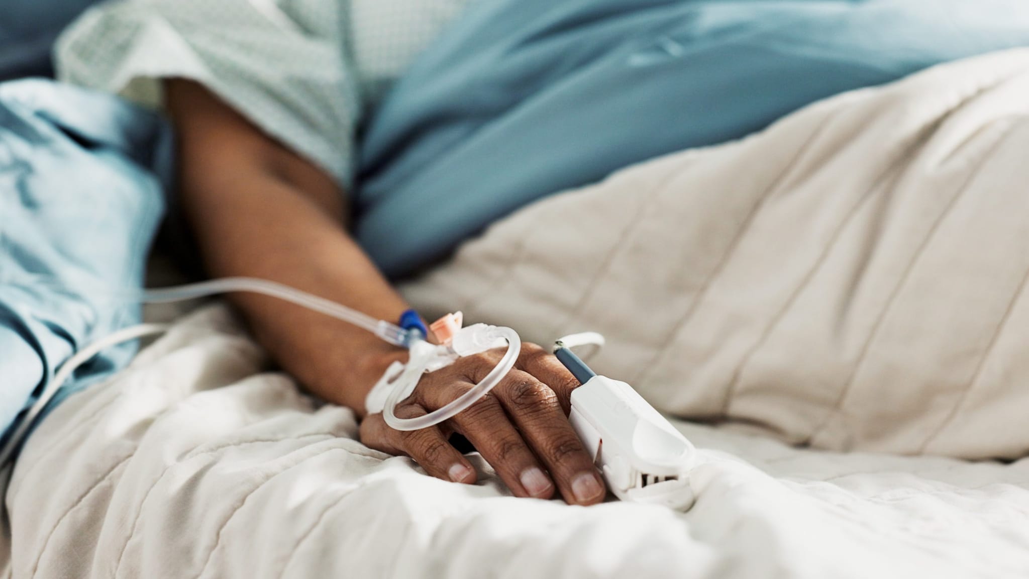 Hand in hospital bed Hand in a hospital bed