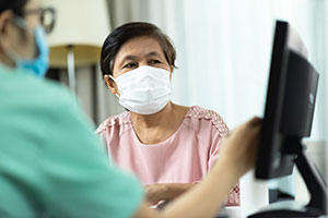 Doctor advising older female patient