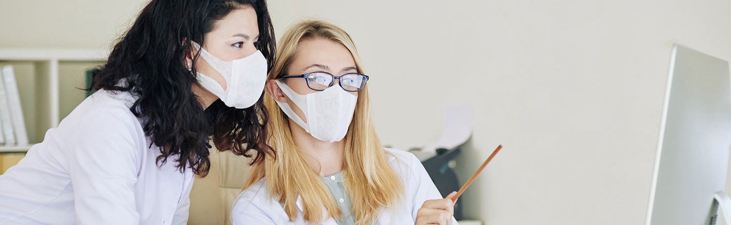 Two healthcare professionals in a meeting. Two healthcare professionals in a meeting.