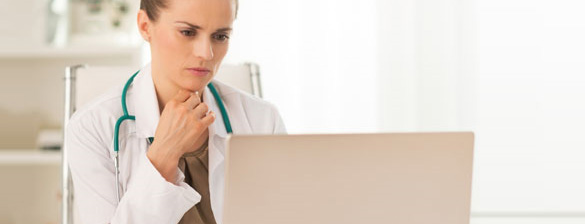 doctor reading from laptop