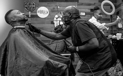 Barber trims customers beard