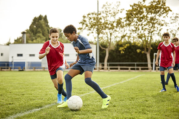 teenaged boys playing soccer