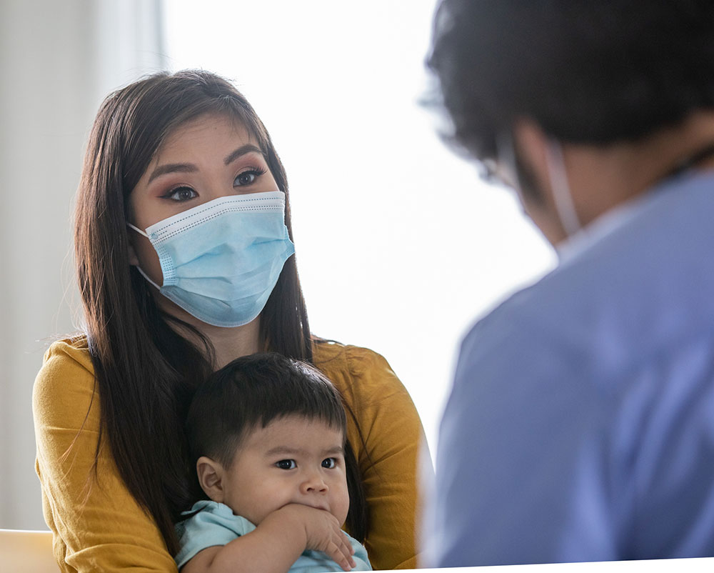 Mother and baby son at an appointment with a doctor.