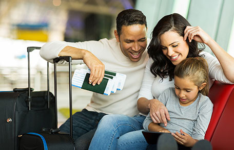 vaccines-before-travel Family of three in an airport waiting