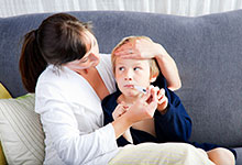 Mother comforting sick child