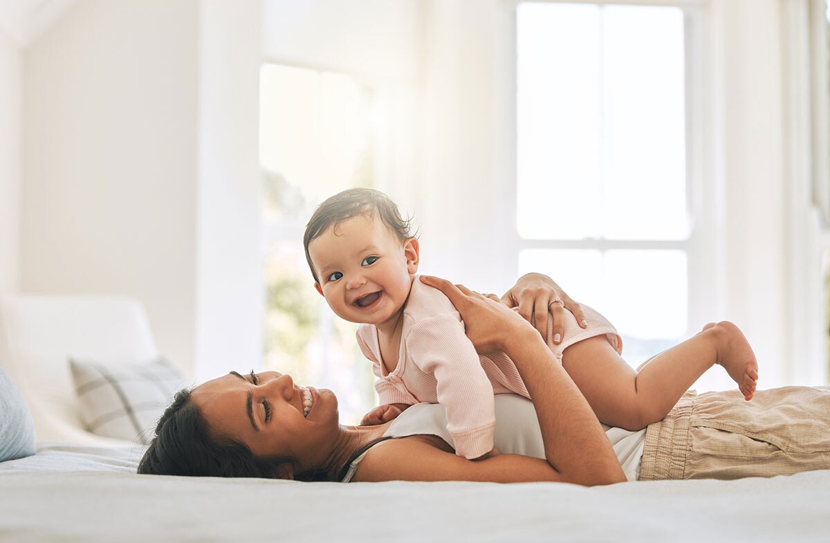 Young woman and her newborn baby at home.