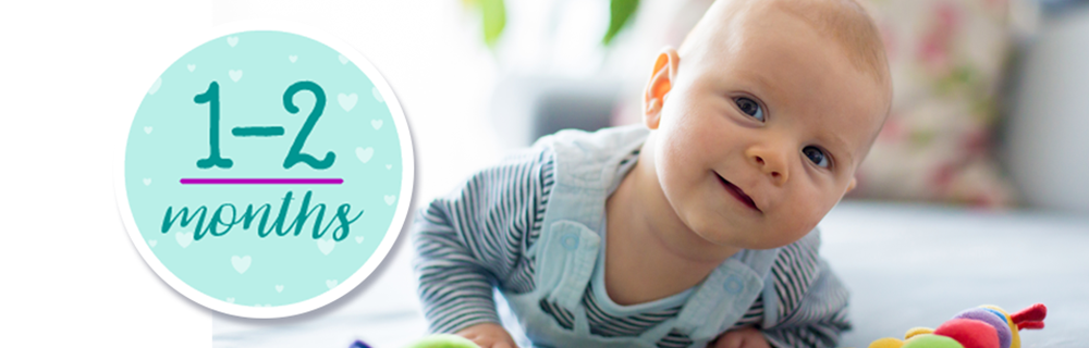 infant tilting his head and smiling, healthy thanks to the vaccines
