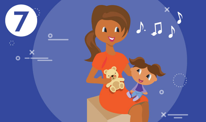 mother singing with her child on her lap holding a teddy bear in her right hand