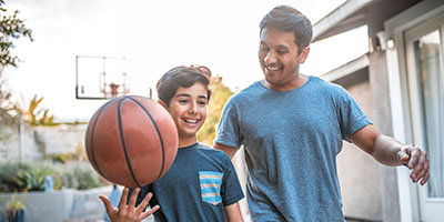 father and son playing basketball