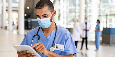 Nurse using digital tablet at hospital