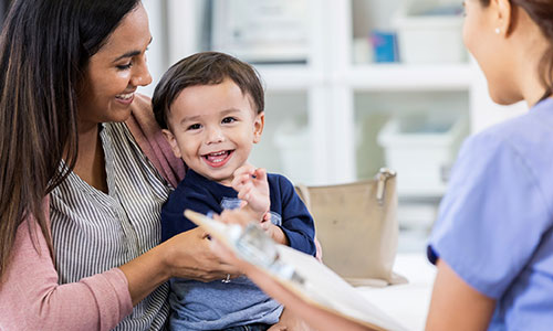 Female doctor talking to a parent.