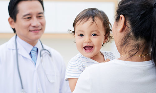 Male doctor talking to a parent.