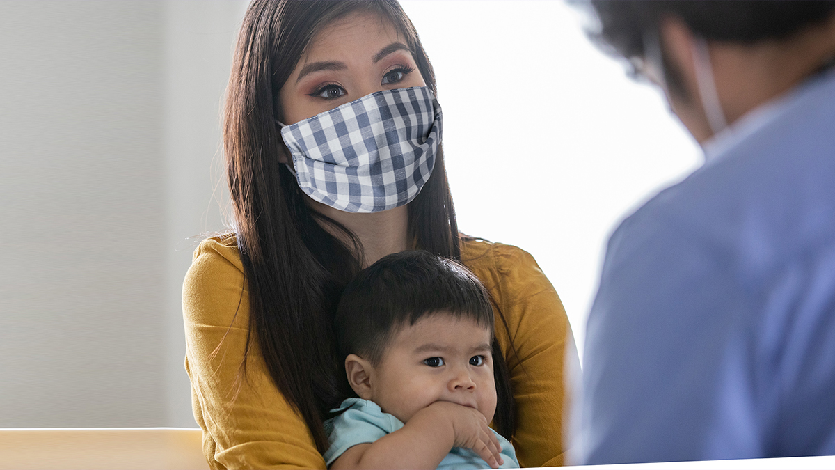 Mother holding child.