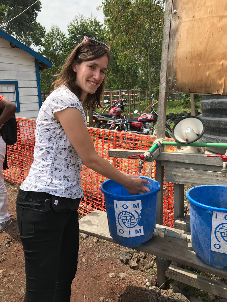 EIS officer Amy Heinzerling washes up at a screening station outside the eastern Congolese city of Goma during her deployment.