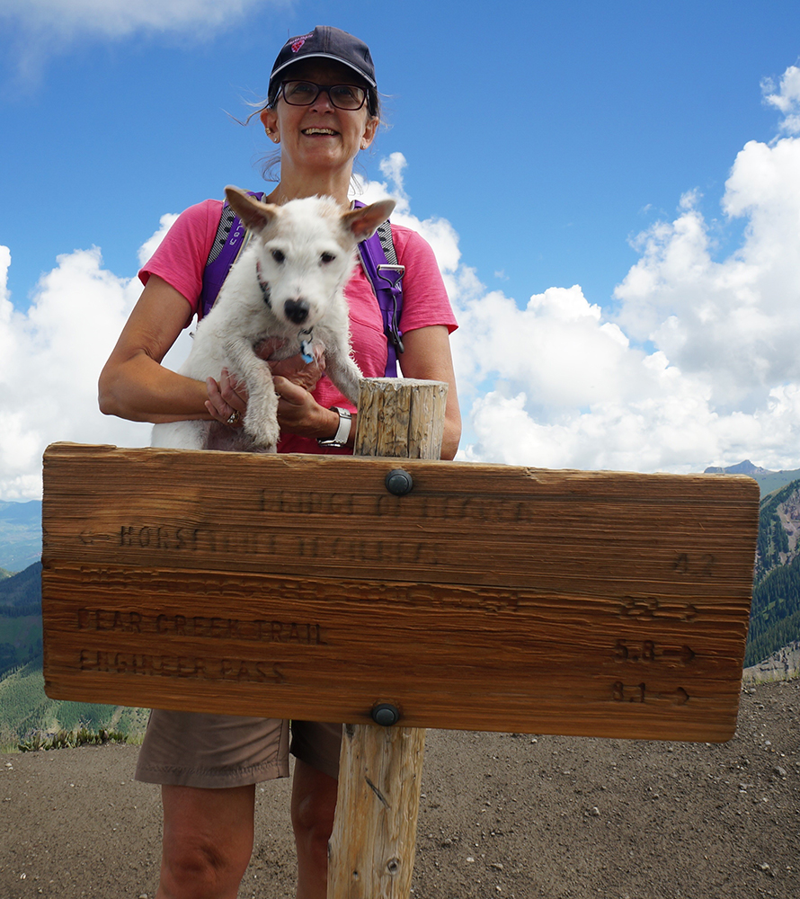 Inger-with-Brutus Woman holding dog over a sign