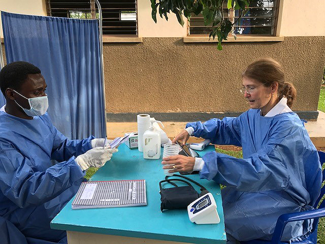 CDC’s Rosalind Carter and a Ugandan colleague prepare to give the Ebola vaccine to health workers in northwestern Uganda in July 2019.