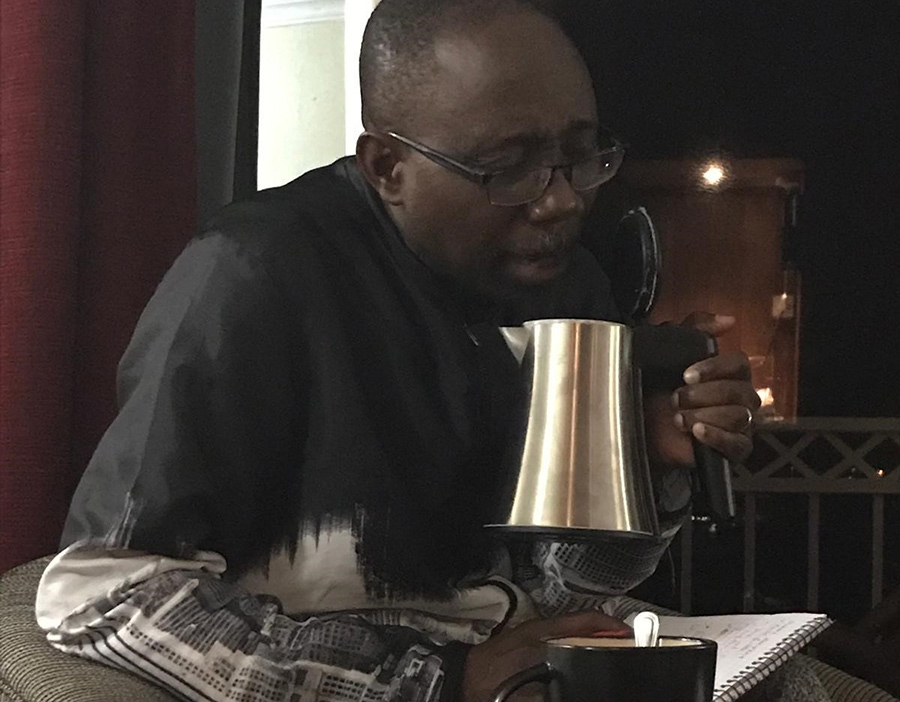 Norbert Soke talking into a coffee cup