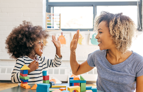 Mother and child sharing a high five
