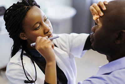 eye doctor giving patient an eye exam