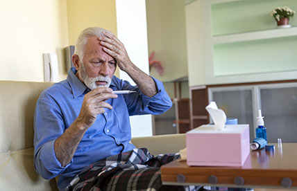 Sick man checking his temperature
