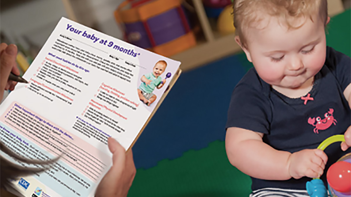 Component 2 - Parent reading about developmental milestones Parent reading about developmental milestones.