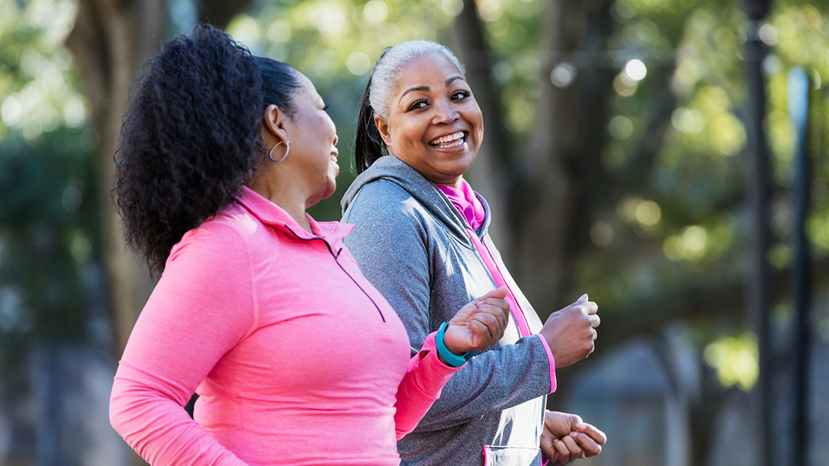 Two women jogging together.