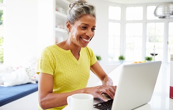 A woman working on a laptop.