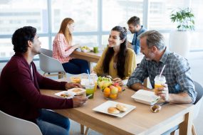 Multigenerational coworkers enjoying a healthy lunch.