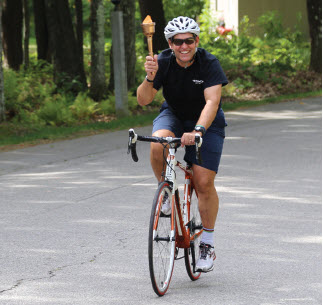 Tom Hussey, owner, on a bicycle