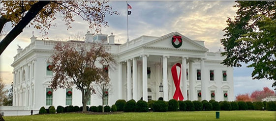 White House decorated with a large red ribbon in recognition of World AIDS Day